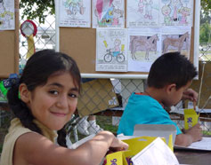 Kids coloring in the coloring contest area.