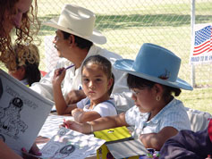 Kids at the safety coloring contest table coloring